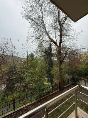 a balcony with a tree and a fence at Green View Studios in Sandanski