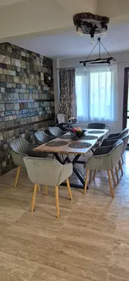 a living room with a dining table and chairs at Къща за гости Брязово in Ribarica