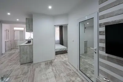 a bathroom with a sink and a tv in a room at Secret Guest House in Plovdiv