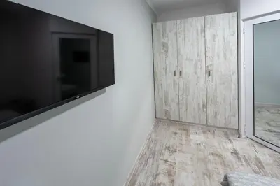 a living room with a large television on a wall at Secret Guest House in Plovdiv