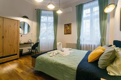 a bedroom with a bed with towels on it at Klimt's Puzzle Suite in Sofia