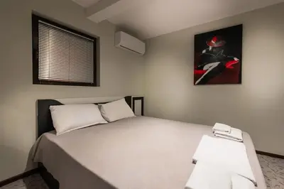 a bedroom with a bed and a painting on the wall at Hotel-Restaurant DIMAX in Yoakim-Gruevo