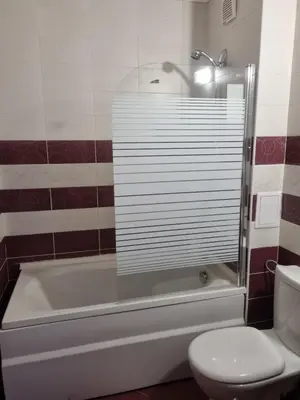 a bathroom with a tub and a toilet and a shower at Ski & View Pamporovo Apartment in Smolyan