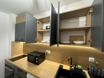a kitchen with a counter with a microwave and a sink at The View Residences & private parking in Sofia