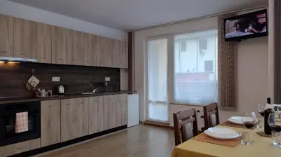 a kitchen with a table and a dining room at Sofia Harmony Tranquility Comfort and Free Parking in Sofia
