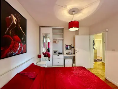 a bedroom with a red bed in a room at Mary's Guesthouse in Banya
