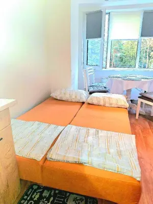 two beds in a room with a table and a window at Apartment B5 5 Relax Chamkoria Borovets in Borovets