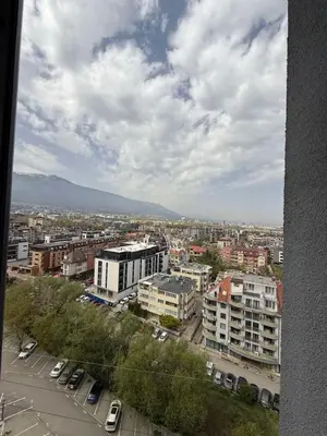 a city with cars parked in a parking lot at The Nest in Sofia