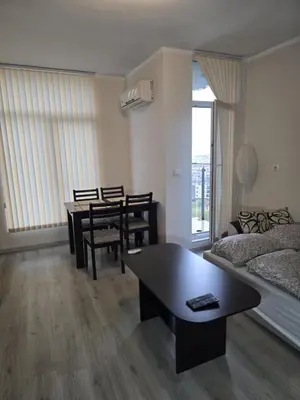 a living room with a couch and a table at The Nest in Sofia