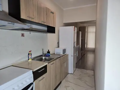 a kitchen with a sink and a white refrigerator at The Nest in Sofia