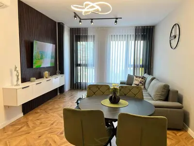 a living room with a couch and a table at City lux apartment in Plovdiv