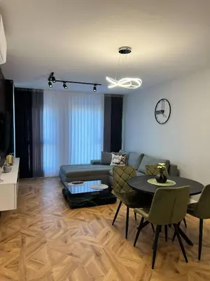a living room with a couch and a table at City lux apartment in Plovdiv
