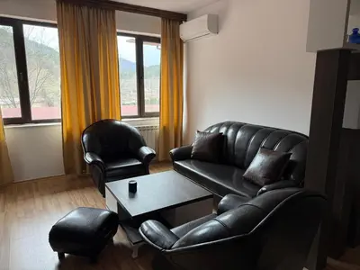 a living room with a leather couch and two chairs at Donna Spa hotel Sveti Spas in Velingrad