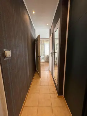 a hallway with black walls and a tile floor at Cozy Corner in Nadezhda in Sofia