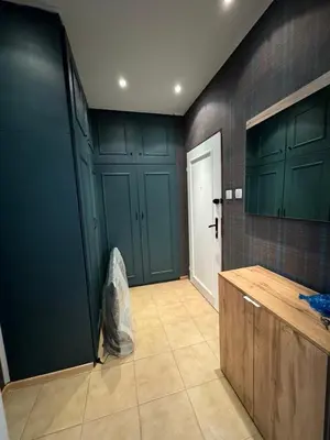 a kitchen with green cabinets and a tiled wall at Cozy Corner in Nadezhda in Sofia