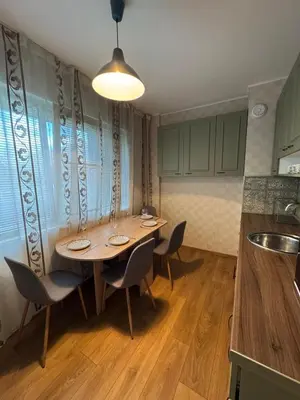 a dining room with a table and chairs in a kitchen at Cozy Corner in Nadezhda in Sofia