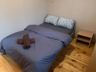 a small bedroom with a bed and a table at West Park Retreat in Sofia