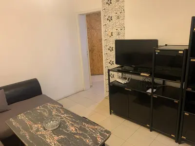 a living room with a flat screen tv and a couch at West Park Retreat in Sofia