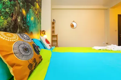 a bedroom with a bed with a colorful blanket at Plovdiv Urban Gem 2BD Apartment by Flat Mаnаger in Plovdiv
