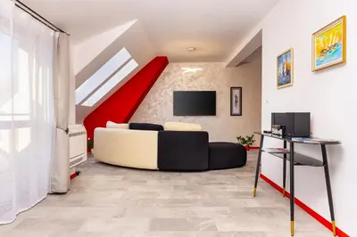 a living room with a couch and a red staircase at Plovdiv Urban Gem 2BD Apartment by Flat Mаnаger in Plovdiv