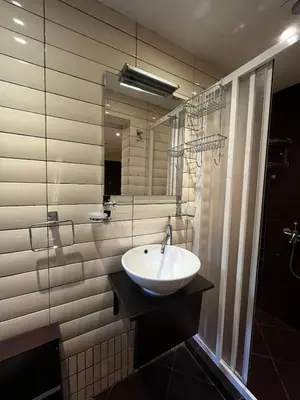 a bathroom with a sink and a glass shower at Sofia Central Cozy Apartment in Sofia