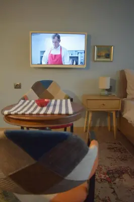 a living room with a flat screen tv on the wall at Studio 42 Plovdiv in Plovdiv
