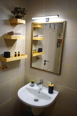 a bathroom with a sink and a mirror at Studio 42 Plovdiv in Plovdiv