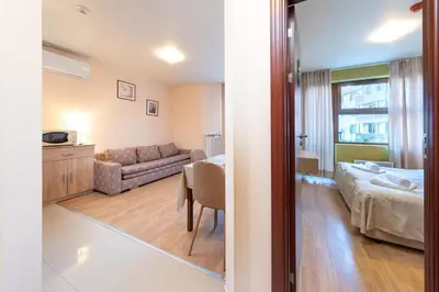 a living room with a bed and a couch at Cozy Mountain-View Apartment in Belmont, Bansko by Flat Mаnager in Bansko