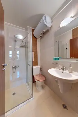 a bathroom with a shower and a sink and a toilet at Cozy Mountain-View Apartment in Belmont, Bansko by Flat Mаnager in Bansko