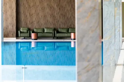a waiting room with green chairs and a pool at Saint Sofia Golf Club, Hotel and SPA in Robertowo