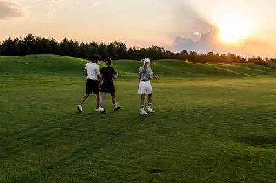 a group of three people standing on a golf course at Saint Sofia Golf Club, Hotel and SPA in Robertowo