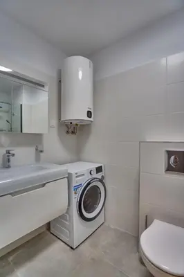 a bathroom with a washing machine and a sink at Toronto Cozy Studio near UNSS and NSA w Fast WiFi in Sofia