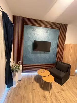 a living room with a couch and a tv and a table at BoxRoom3 in Kyustendil