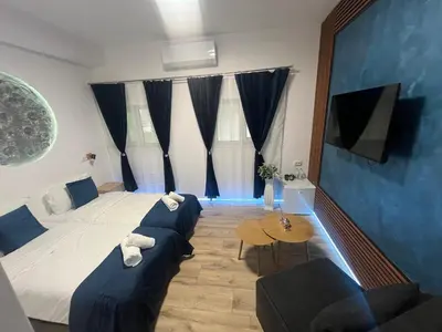 a bedroom with a bed and a couch and a table at BoxRoom3 in Kyustendil