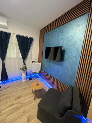 a living room with a couch and a flat screen tv at BoxRoom3 in Kyustendil
