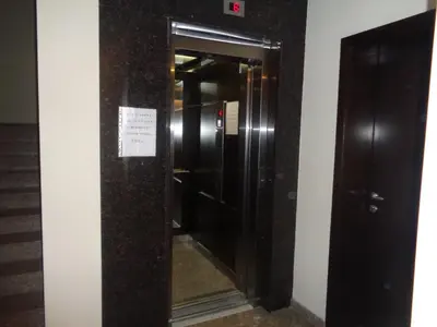 an empty elevator in a building with a sign on it at 