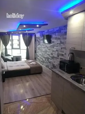 a bedroom with a bed in a room with a kitchen at 