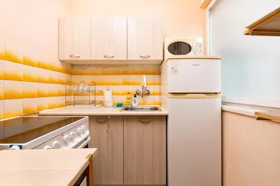 a small kitchen with a refrigerator and a sink at 1-Bedroom Flat with Balcony in Plovdiv by Flat Mаnager in Plovdiv