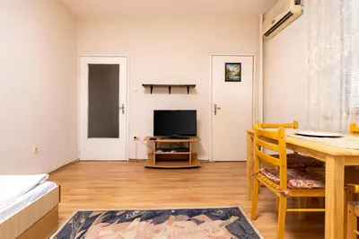 a living room with a table and a television at 1-Bedroom Flat with Balcony in Plovdiv by Flat Mаnager in Plovdiv