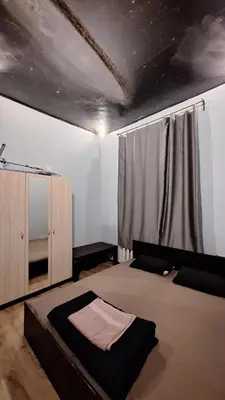 a bedroom with a large bed and a window with at Key Hostel Serdika in Sofia