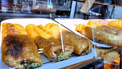a display case with various types of bread and croissants at Key Hostel Serdika in Sofia