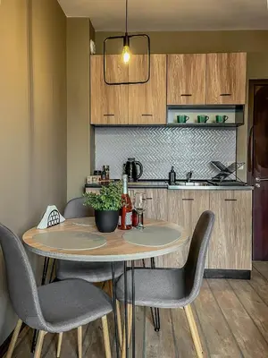 a dining room table with chairs and a kitchen at Tarein Studio in Bansko