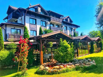 a large house with a garden in front of it at Хотел Валентино 2 in Dobrinishte