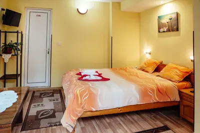a bedroom with a large bed in a room at Лазов in Sapareva Banya