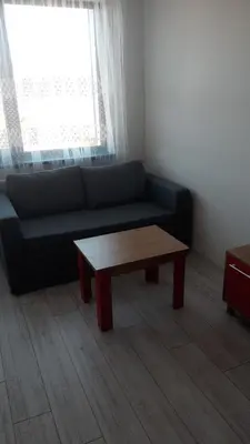 a living room with a couch and a coffee table at ТЕС Боровец Гарденс in Borovets