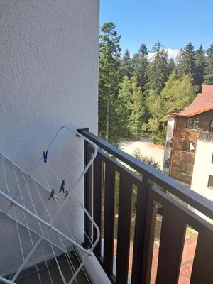 a view from a balcony with birds on the wall at ТЕС Боровец Гарденс in Borovets