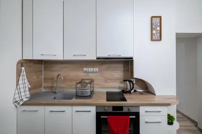 a kitchen with white cabinets and a sink at Central 1BD Next to Womens Market and Sofia's Gems by Flat Mаnаger in Sofia