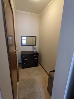 a small room with a mirror and a dresser at Spacious modern 1BR apartment near the gondola in Bansko