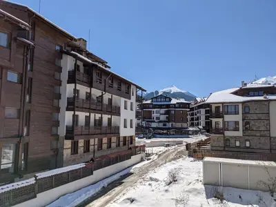 a view from the balcony of a building in the snow at Spacious modern 1BR apartment near the gondola in Bansko
