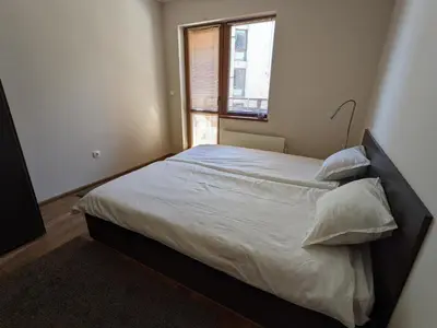 a large bed in a bedroom with a window at Spacious modern 1BR apartment near the gondola in Bansko